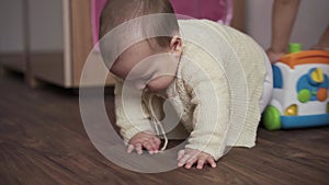 Infant, childhood concept - happy funny playfull toddler kid 8 month baby girl sit play in playroom. chubby active awake