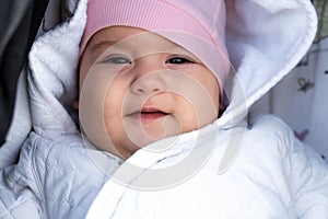 Infant, childhood, emotion concept - close-up of cute smiling portrait face of brown-eyed chubby newborn awake toothless