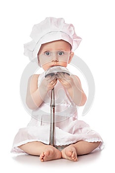 Infant cook baby portrait wearing apron and chef hat with metal ladle, isolated on a white background