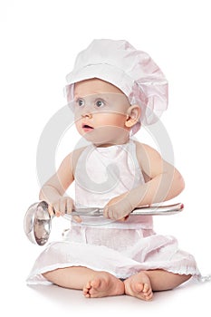 Infant cook baby portrait wearing apron and chef hat with metal ladle, isolated on a white background. with free space for text