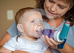 Infant getting breathing treatment from mother