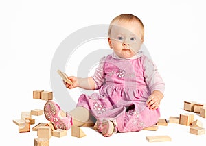Infant girl playing with wooden blocks