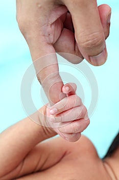 Infant gripping parents finger