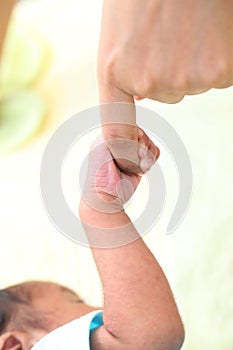 Infant gripping parents finger