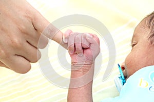 Infant gripping parents finger