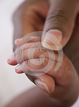 Infant hand in mother's hand