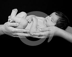 Infant held in parents` hands