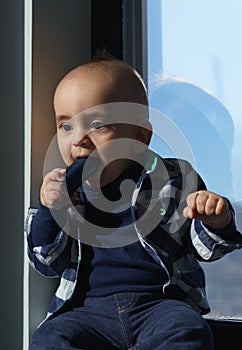 infant kid holding a headset and put it in his mouth