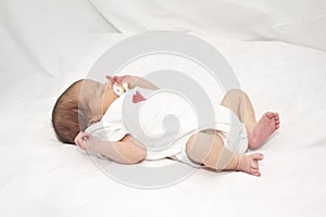 Infant laying on her back photo