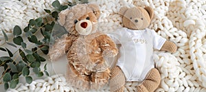 Infant onesie mockup with teddy bear, eucalyptus branch on white ivory blanket background