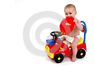 Infant sitting on push toy