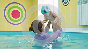 Infant swimming lesson with instructor