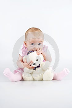 Infant with teddy - bear.