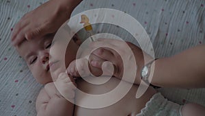 Infants, childhood, illness, medicine and health, covid-19, pandemic - close-up of female hands measure temperature with