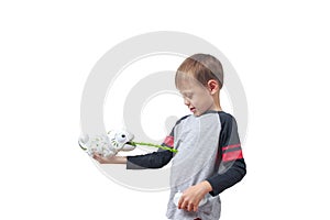 Infatuated child boy playing plastic toy lizard robot with a remote control, isolated on white background. The nano-toy Chameleon photo