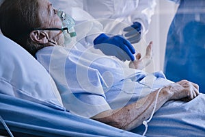 Infected patient lying on bed during takecare of Doctor and nurse with x-ray Lung in quarantine room