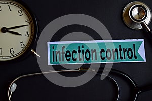 Infection Control on the print paper with Healthcare Concept Inspiration. alarm clock, Black stethoscope. photo