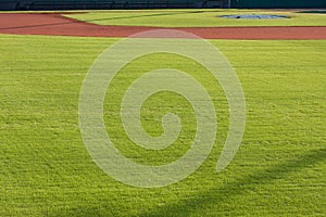 Infield Dirt And Outfield Grass Of Baseball Field