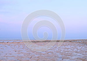 Infinite Horizon over Ocean with Puddles of Water on Beach during Low Tide and Clear Sky - Natural Background photo