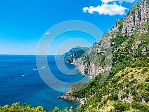 Infinite view of wild coastline cliff covered with trees at Positano, Amalfi Coast, Naples, Italy