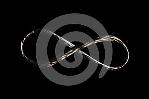 infinity loop, symbol of endlessness and change, on black background photo