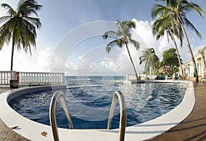 Infinity pool with float caribbean sea