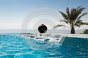 Infinity pool jacuzzi, azure water. Luxury lifestyle, tropical resort concept.