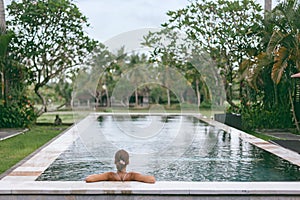 Infinity pool with a view on palm trees, Ubud, Bali