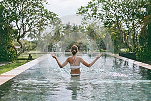 Infinity pool with a view on palm trees, Ubud, Bali