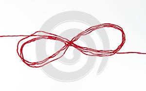 infinity sign with red woolen threads,