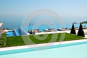 Infinity swimming pool by beach at the modern luxury hotel