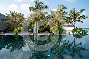 Infinity swimming pool beautiful landscape with ocean and tropical beach view