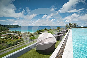 Infinity swimming pool and chair with a view on Phuket Sea