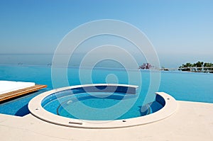 Infinity swimming pool with jacuzzi by beach