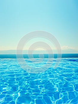 Infinity swimming pool with sea and Mountain