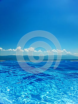 Infinity swimming pool with sea and Mountain