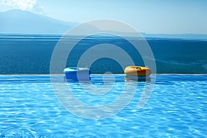 Infinity swimming pool with sea and Mountain View