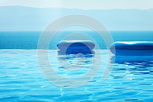 Infinity swimming pool with sea and Mountain View