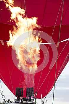 Inflames fire and inflates the balloon.Detail of a large hot air balloon being inflated for its initial flight
