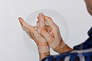 Inflammation of Asian man thumb and hand. Concept of arthritis and finger problems