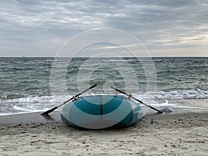 Inflatable boad on the beach on sunset