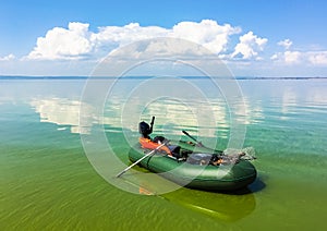 Inflatable boat in the calm river in sunny day