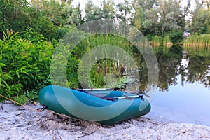 Inflatable boat on lake shore