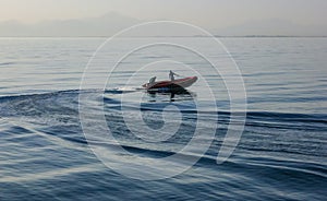 inflatable boat with sailors to provide divers near a coral reef in the Red Sea, Egypt