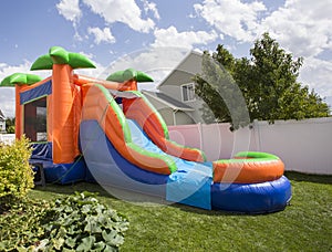 Inflatable bounce house water slide in the backyard