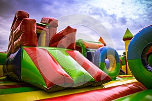 Inflatable castle labirynth slide in a playground against the blue sky