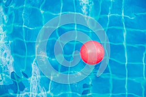 Inflatable colorful ball floating in a swimming pool