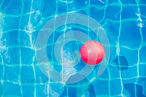 Inflatable colorful ball floating in a swimming pool