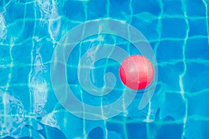 Inflatable colorful ball floating in a swimming pool