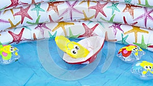 Inflatable colorful kid toys floating in an inflatable swimming pool